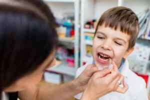 cute boy with speech therapist is taught pronounce letters words sounds