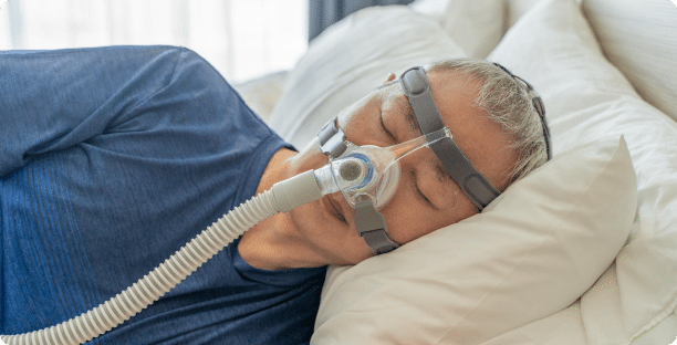 Middle age man wearing cpap mask