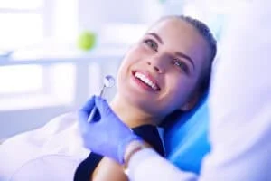 young female patient with pretty smile examining dental inspection dentist office