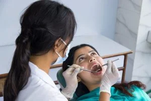 asian dentist checking up her patient female dentist female patient hospital