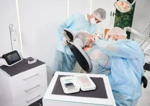 dentist using dental implant machine implantology procedure 1